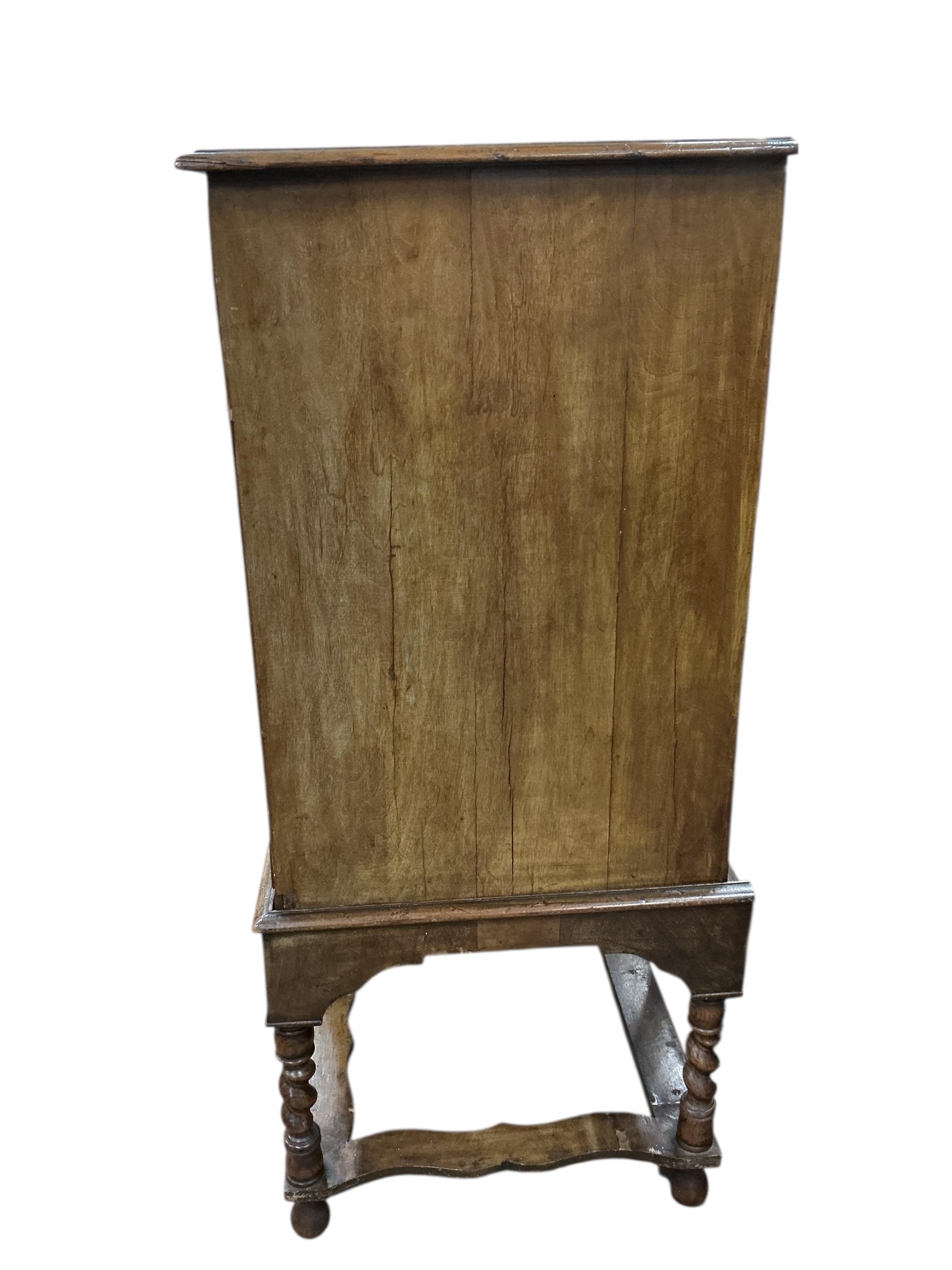 An 18th century banded walnut chest on stand, width 99cm, depth 54cm, height 128cm